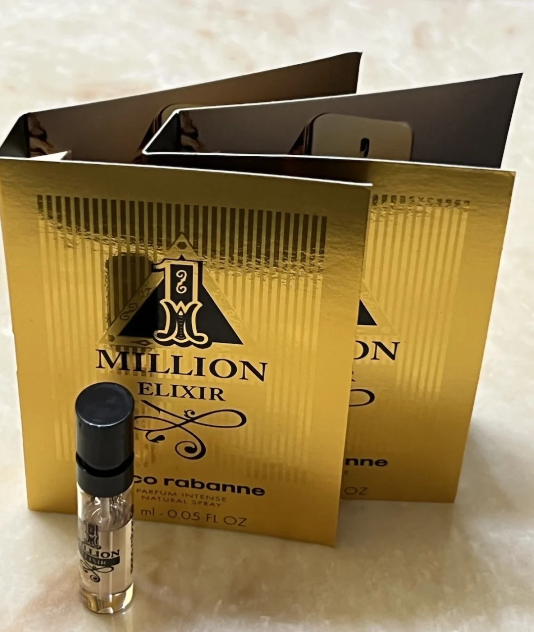 Gold 1 Million Elixir sample vial and cards